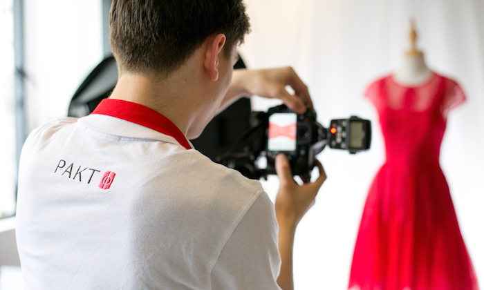 man photographing a red dress