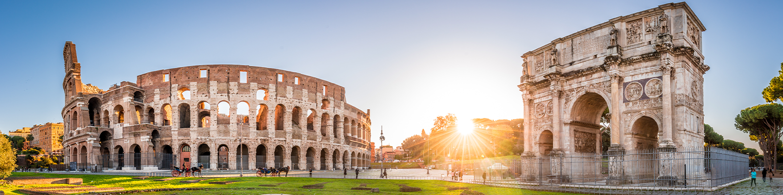 Panoramic view of Colosseum and Constantine arch at sunrise. Rome, Italy