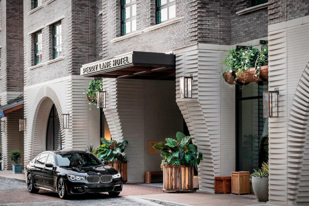 Front entrance to the Perry Lane Hotel, A Luxury Collection Hotel, Savannah with black BMW parked in the front.